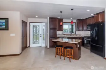 Beautiful glass front door, entry closet/pantry and open kitchen