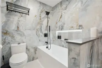 Luxurious upgrades to the main bath. Heated tile flooring, deep soaking tub, some niches and special lighting create a spa feel.