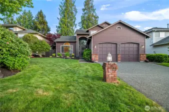 Beautifully maintained home with striking curb appeal, mature landscaping, and a welcoming covered entry. Quiet street with a level driveway and manicured lawn.