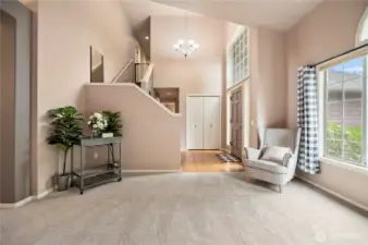 Grand entry with soaring ceilings, natural light, and a stylish two-tone wall palette creates a warm and elegant welcome.