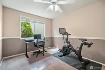 Versatile room with large window and ceiling fan—works great as a study, fitness room, or guest bedroom.