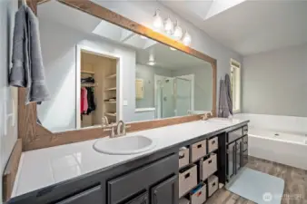 Oversized mirror, twin sinks, and updated fixtures provide everyday convenience.