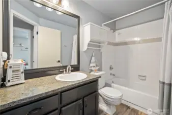 Granite countertops, updated fixtures, and tile tub surround.