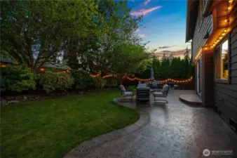 Evening glow and fire pit-ready seating make this backyard a year-round favorite.