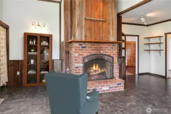 The kitchen has a French, rustic feel about it with wood trim and the wood fireplace. A forged metal rack above the fireplace can hold several pots and pans.