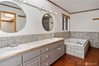 The spacious primary ensuite has dual sinks, a large soaking tub, separate shower and walk-in closet. It is ready for your updates and personal touches.