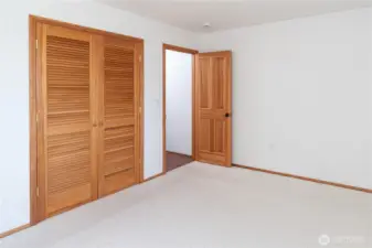 The upper level, water view bedroom has a spacious closet and sits privately away from the other guest bedroom.