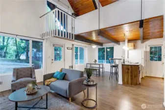 Step inside to this charming cabin with soaring vaulted ceilings and a loft