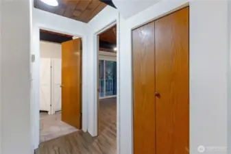 To the right is a closet, then the main floor bedroom and finally the bathroom entrance on the left.