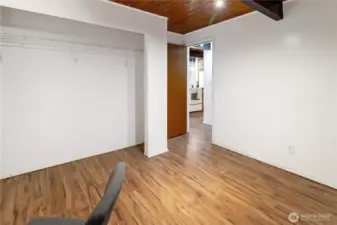 Main floor bedroom closet, peeking back into the hallway