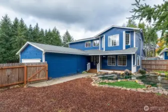 Entry to Home with Covered Front Porch Deck and Fish Pond