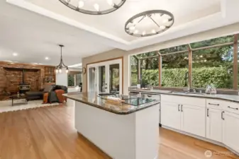Open to the kitchen, the family room provides a relaxed gathering space that feels both airy and connected. The seamless flow between spaces makes it ideal for daily living and entertaining alike. The Kitchen eating area opens through French Doors to the expansive back patio.