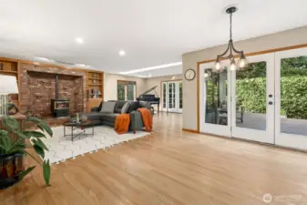 The spacious family room offers an inviting place to gather, featuring generous proportions and an easy flow for everyday living. French doors off of the music room open to the covered back deck, extending the living space outdoors and creating the perfect setting for year-round entertaining or quiet relaxation surrounded by nature.