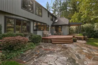 Step outside to a private back deck and flagstone patio that opens to lush greenery. It’s the perfect setting for outdoor dining, morning coffee, or peaceful reflection.