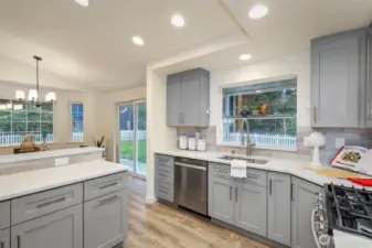 Garden window, sunny breakfast bar, and tons of storage round out the kitchen.