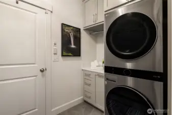 Upgraded washer and dryer, custom built ins and huge custom pantry on opposite wall