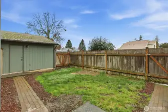 Large courtyard perfect for pets and play. door on the left leads to the garage. 2 locking gates as well.