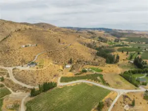 The smaller orchard follows the road along with the property adjacent to it as the road curves.
