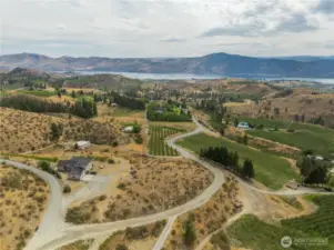 The neighbor to the left abuts the vacant land that follows the curve in the road on down to the orchard and worker housing.
