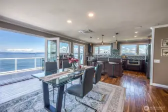 As you sit at the dining room table, enjoying a quiet breakfast, or perhaps hosting a candlelit dinner, the view out to the water is ever-present, expansive, and quietly captivating.
