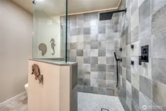 This custom walk in shower is a seamless extension to the bedroom's luxury. Any guest would love staying here and enjoying this remarkable bath.