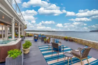 Step outside onto a beautifully designed patio retreat, where every corner invites you to relax, unwind, and connect with guests. Imagine soaking in the hot tub on a star-filled evening with nothing but the sound of waves lapping gently against the sea wall.