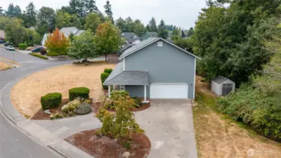 Circle driveway with plenty of room for parking and a two car garage.