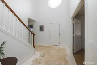 Entryway includes a large open space with chandelier.