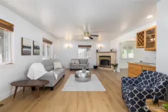 Open living room space with wet bar and fireplace.