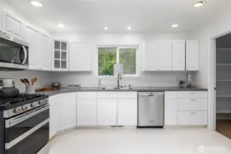 Two large pantries add to the enormous storage solutions in this kitchen.