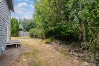 Backyard privacy with green space buffer.