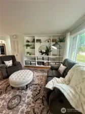 Upon entering the front door you're greeted with custom built-ins in the living space.
