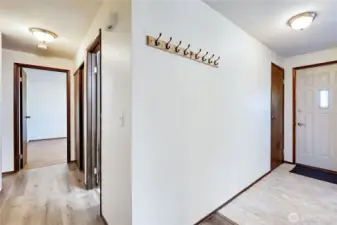 The hallway off the living room leading to all 3 bedrooms