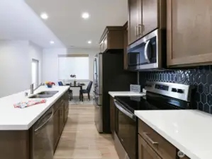 All stainless appliances stay with sale of home. Tile backsplash. Upgraded handles. Granite countertops.