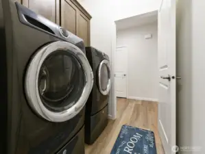 Utility Room with extra Cabinets above washer and dryer. Washer and dryer stay with sale of home.