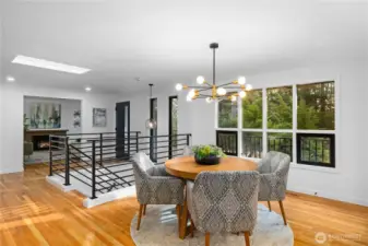 Dining area positioned to capture natural light and peaceful wooded outlooks, with open sightlines to the main living spaces.