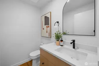 Updated powder room with quartz countertops, modern fixtures, and clean, contemporary finishes.