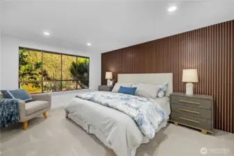 Primary suite with feature wall, expansive window, and a calm, private atmosphere—the perfect   place to begin and end the day.