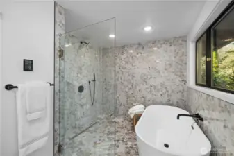 Freestanding soaking tub and oversized walk-in shower create a true retreat—because mornings (and evenings) should feel a little more luxurious.