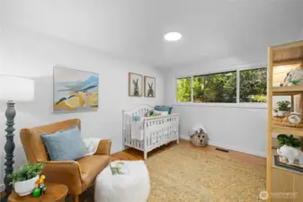 Sunlit bedroom with updated flooring and calming garden views, a space that easily evolves with life’s next chapter.