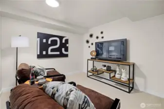 Additional lounge or media space offers flexibility for movie nights, gaming, or quiet retreat from the main living areas above.