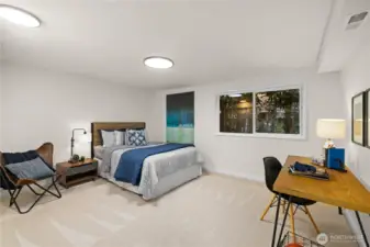 Generous bedroom with new carpet, updated lighting, and space for both rest and productivity.