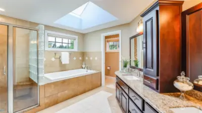 The primary bath has been fully updated with heated tile floors, jetted tub and a large glass enclosed shower.  A extra large skylight keeps light pouring into the bathroom.