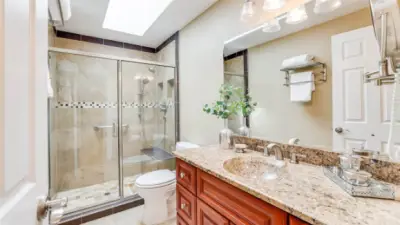 The 3/4 hall bath has been fully updated with granite counters and tile floors.  A light filled skylight keeps the bath open and airy.