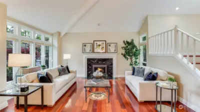 The living room has a open airy feeling and features immaculate white enamel woodwork.
