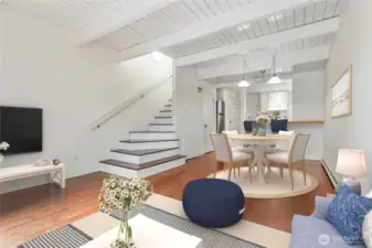 Tall ceilings with white wood plank details give it that beachy vibe. Nice open living room space. Virtually staged.