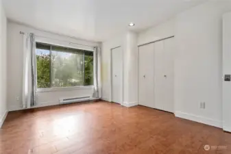 Two closets and a large picture window in the primary bedroom.