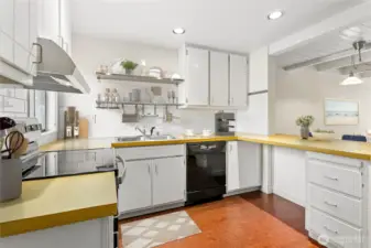 Newer appliances and functional shelving, subway tile backsplash and freshly painted cabinet faces. Virtually staged.