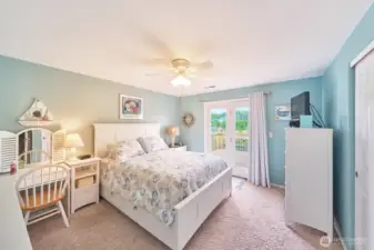 Upstairs bedroom #1 with French doors to the upper deck looking over the canal.