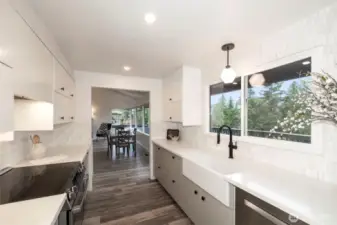 Main Level Kitchen recently remodeled with Quartz countertops, Fireclay farmhouse sink, Kohler Kitchen faucet and Bosch appliances. Carrara marble mosaic backsplash.